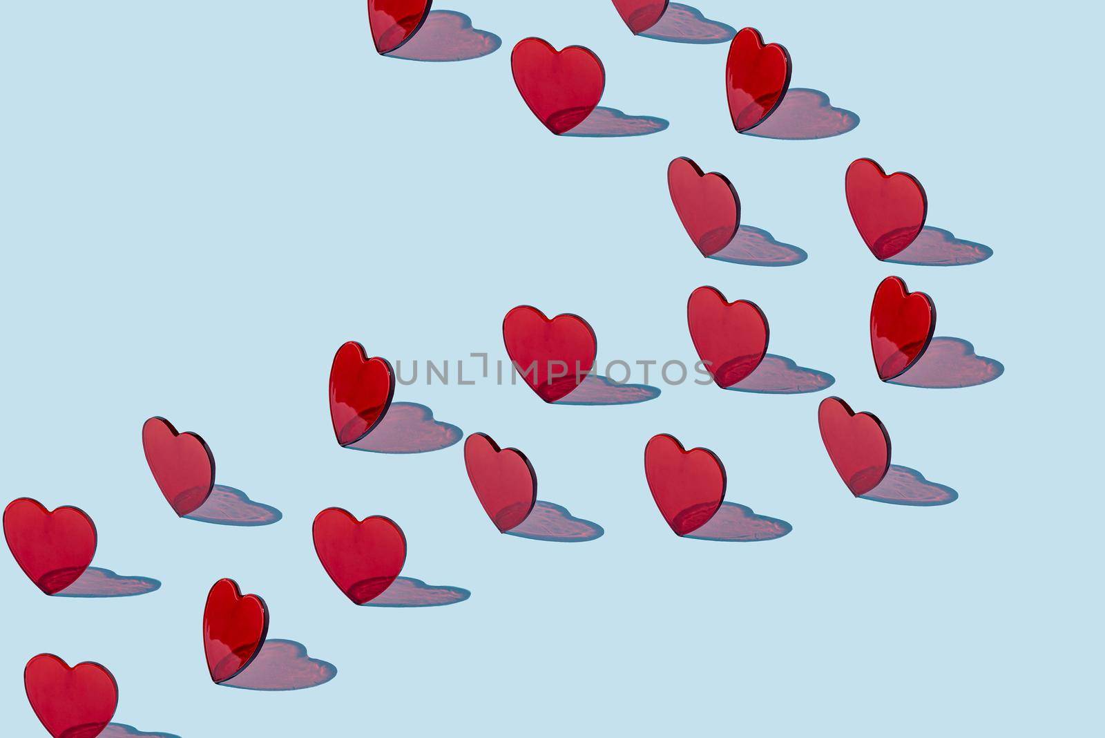 Creative pattern of red hearts on a blue background. Valentine's day concept. Isometric layout.