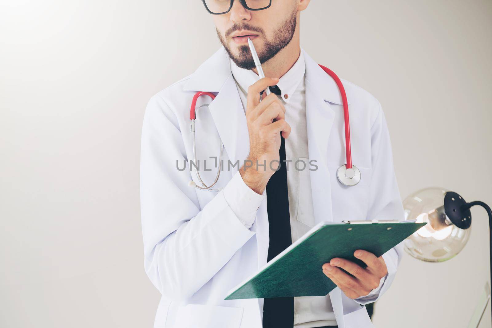 Doctor holding patients health file at office table in the hospital. Medical and healthcare concept.