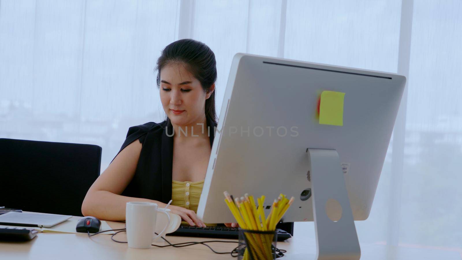 Businesswoman using desktop computer in office. Business concept.