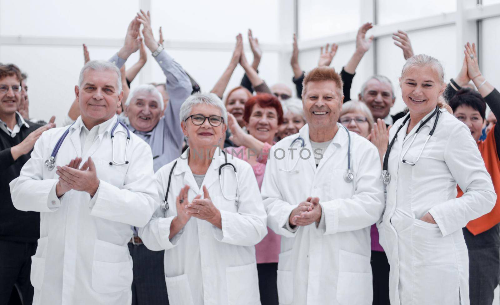 Group of the patients celebrate their recovery together with doctors