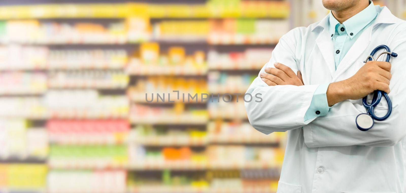 Male pharmacist standing in the drugstore pharmacy. Medical healthcare and pharmaceutical service.