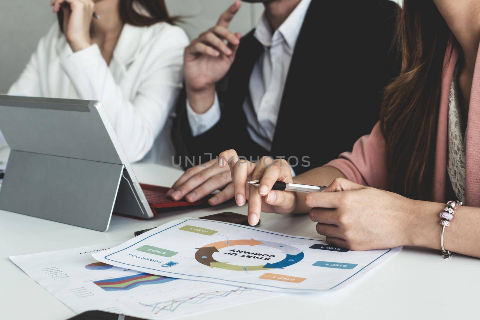 Businessman and businesswomen working in office. by biancoblue