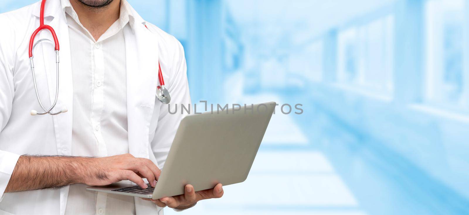 Doctor using laptop computer at the hospital. Medical healthcare and doctor staff service.