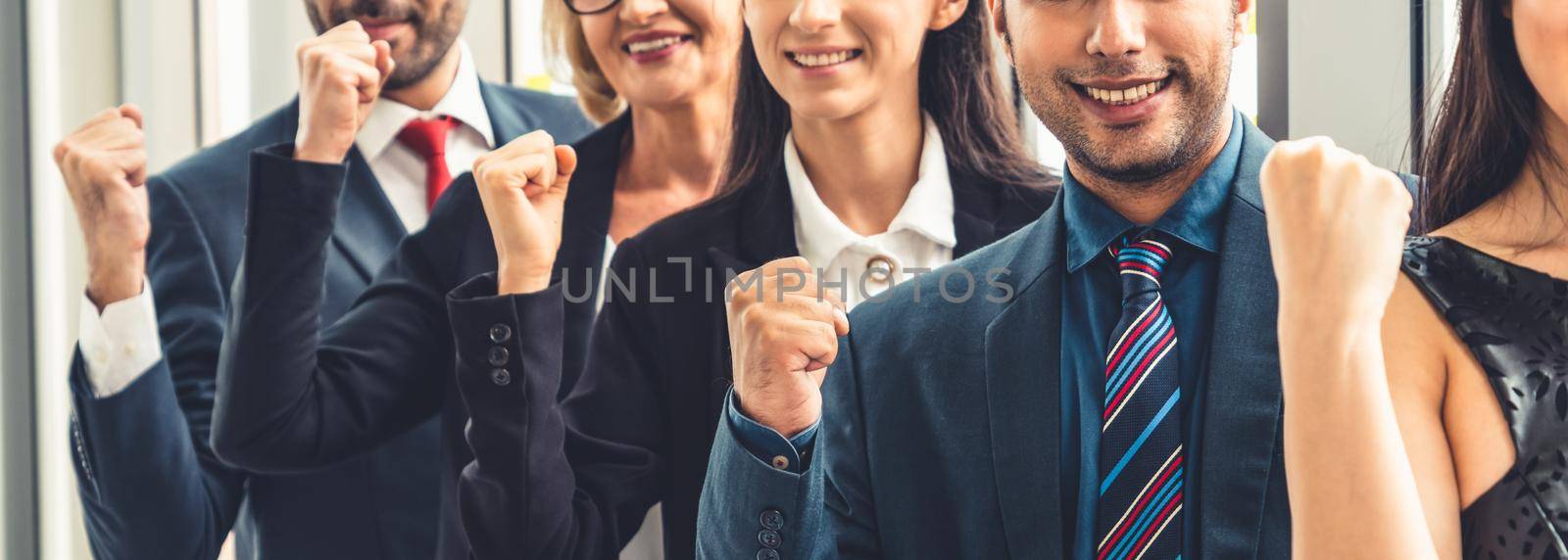 Successful business people standing together showing strong relationship of worker community. A team of businessman and businesswoman expressing a strong group teamwork at the modern office.