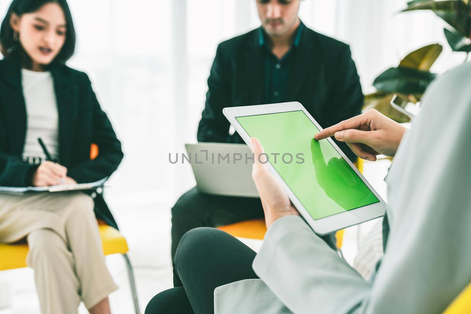 Businesswoman in business meeting using computer proficiently at office room . Corporate business team collaboration concept .
