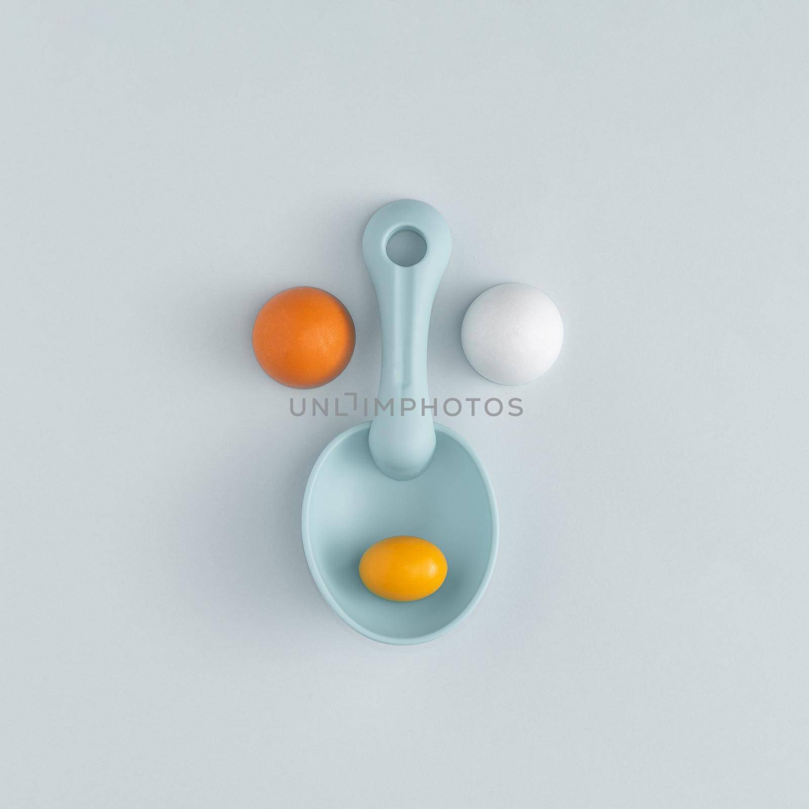 Plastic beach toys. Creation arranged in the shape of a face on a blue background. Abstract concept. Square layout flat lay with copy space