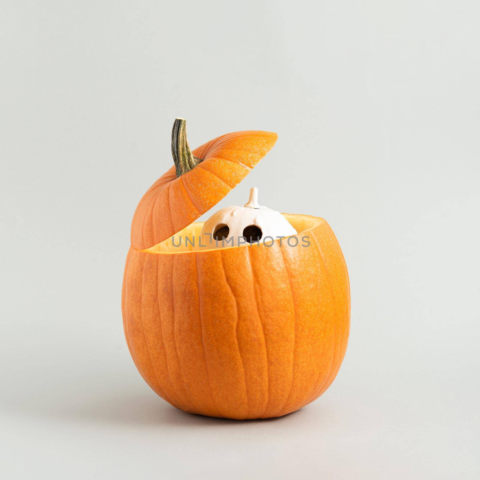 White Halloween pumpkin like a ghost peep out from the large pumpkin. by Nemo_Family