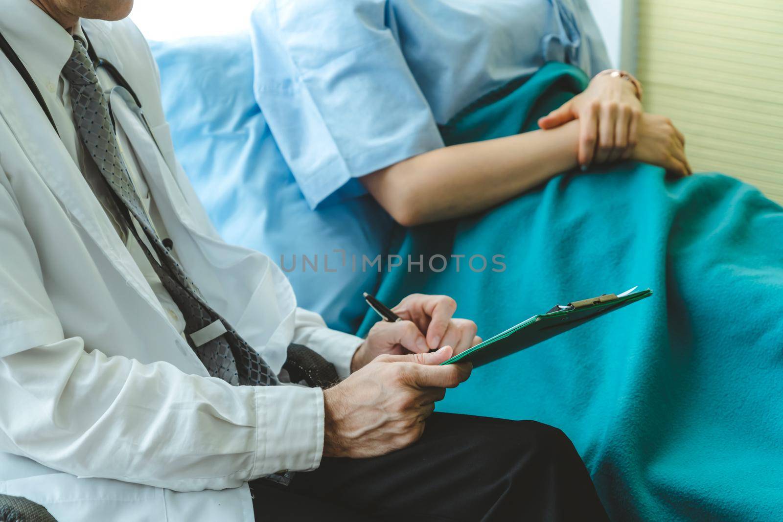 Doctor in professional uniform examining patient at hospital or medical clinic. Health care , medical and doctor staff service concept.