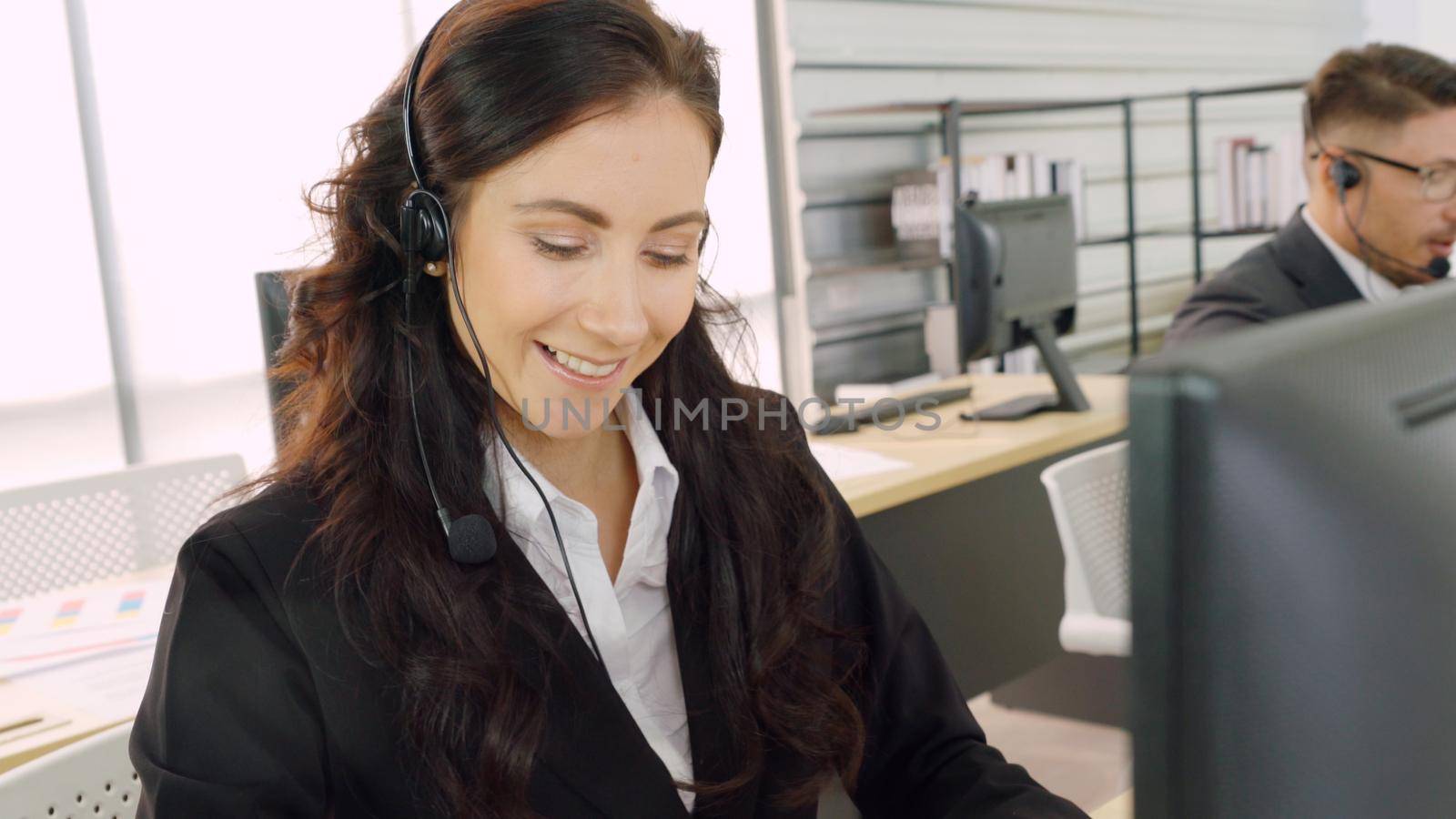 Business people wearing headset working in office to support remote customer or colleague. Call center, telemarketing, customer support agent provide service on telephone video conference call.