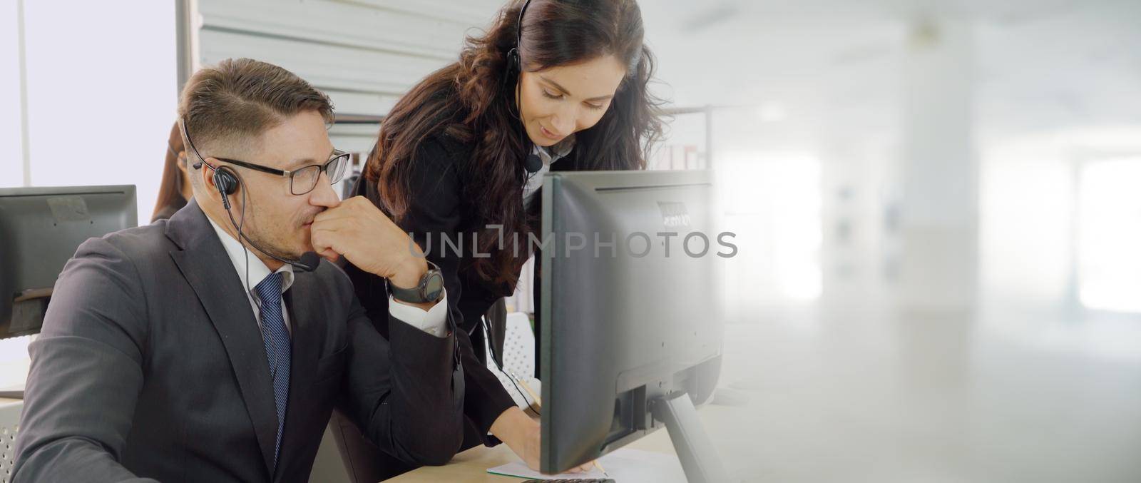 Business people wearing headset working in office broaden view by biancoblue