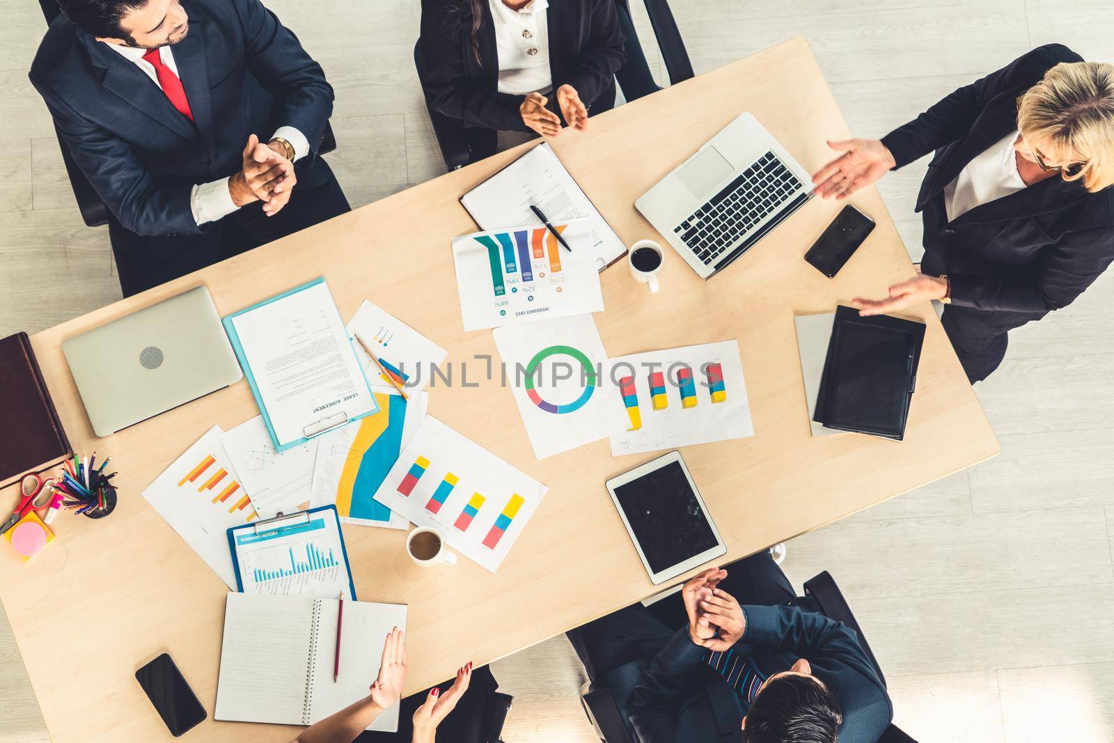 Business people group meeting shot from top view in office . Profession businesswomen, businessmen and office workers working in team conference with project planning document on meeting table .