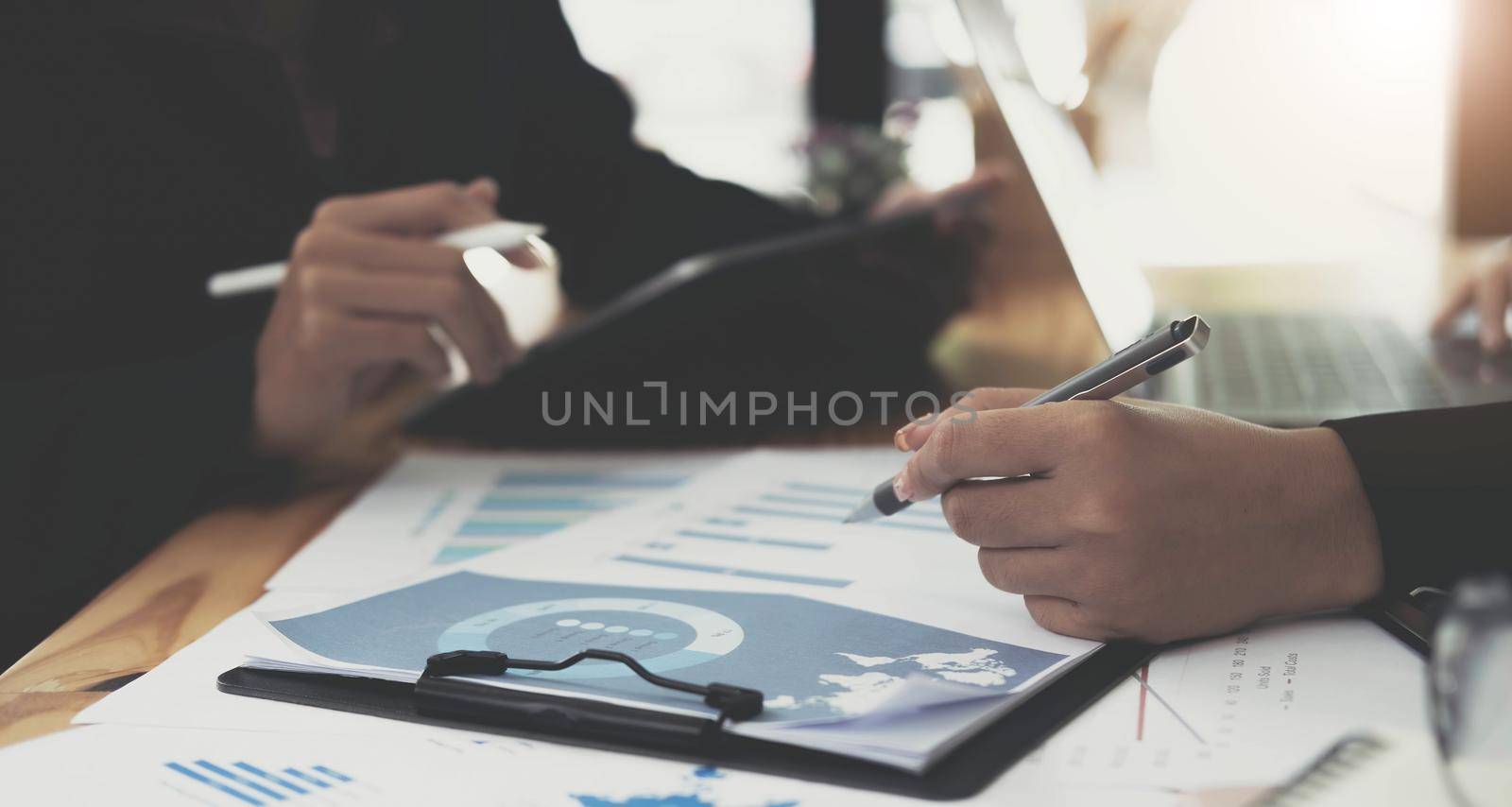 Close up of Business team analyzing income charts and graphs with modern laptop computer. Business analysis and strategy concept..