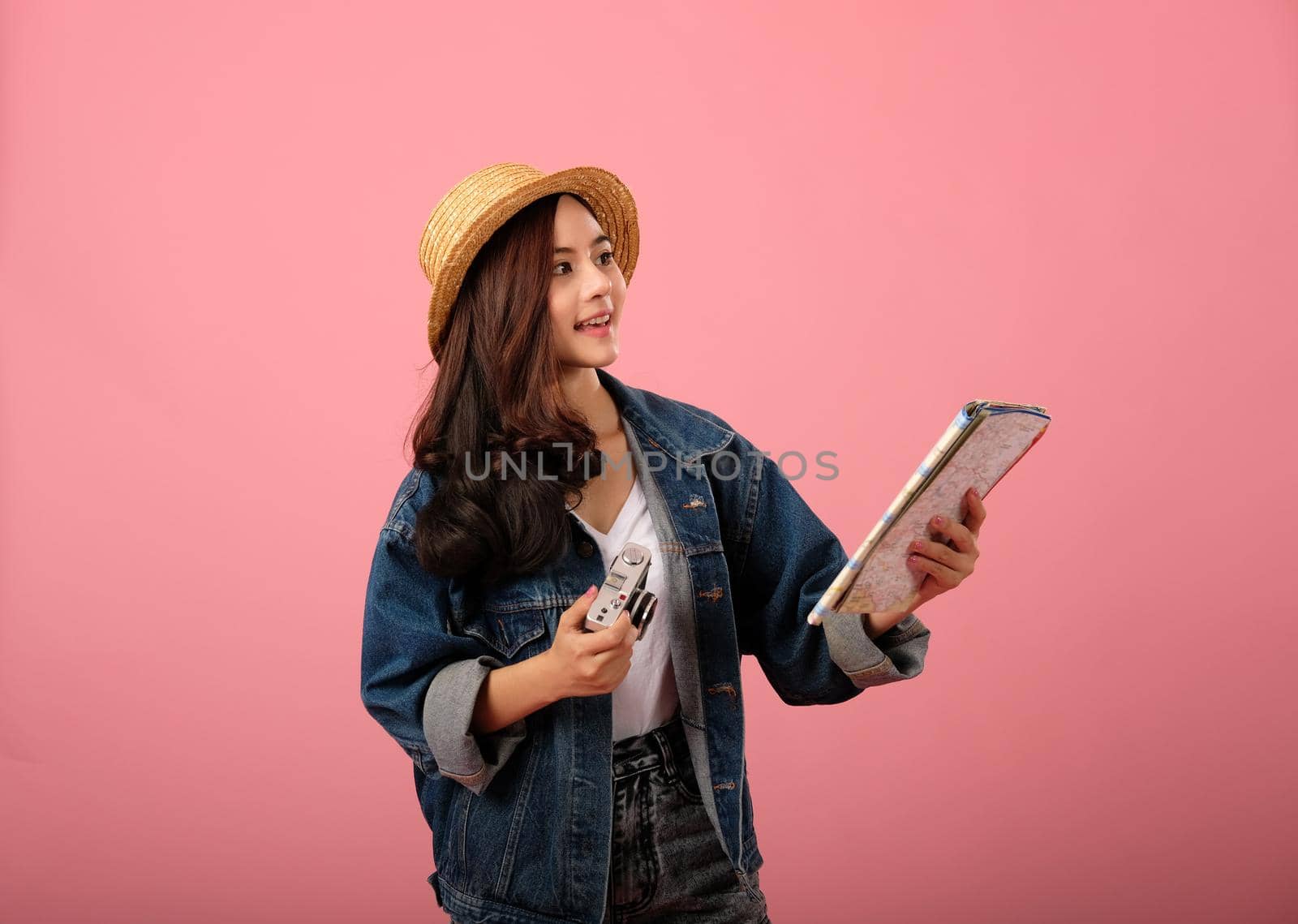 young asian woman backpacker traveler with camera map. map. studio shot