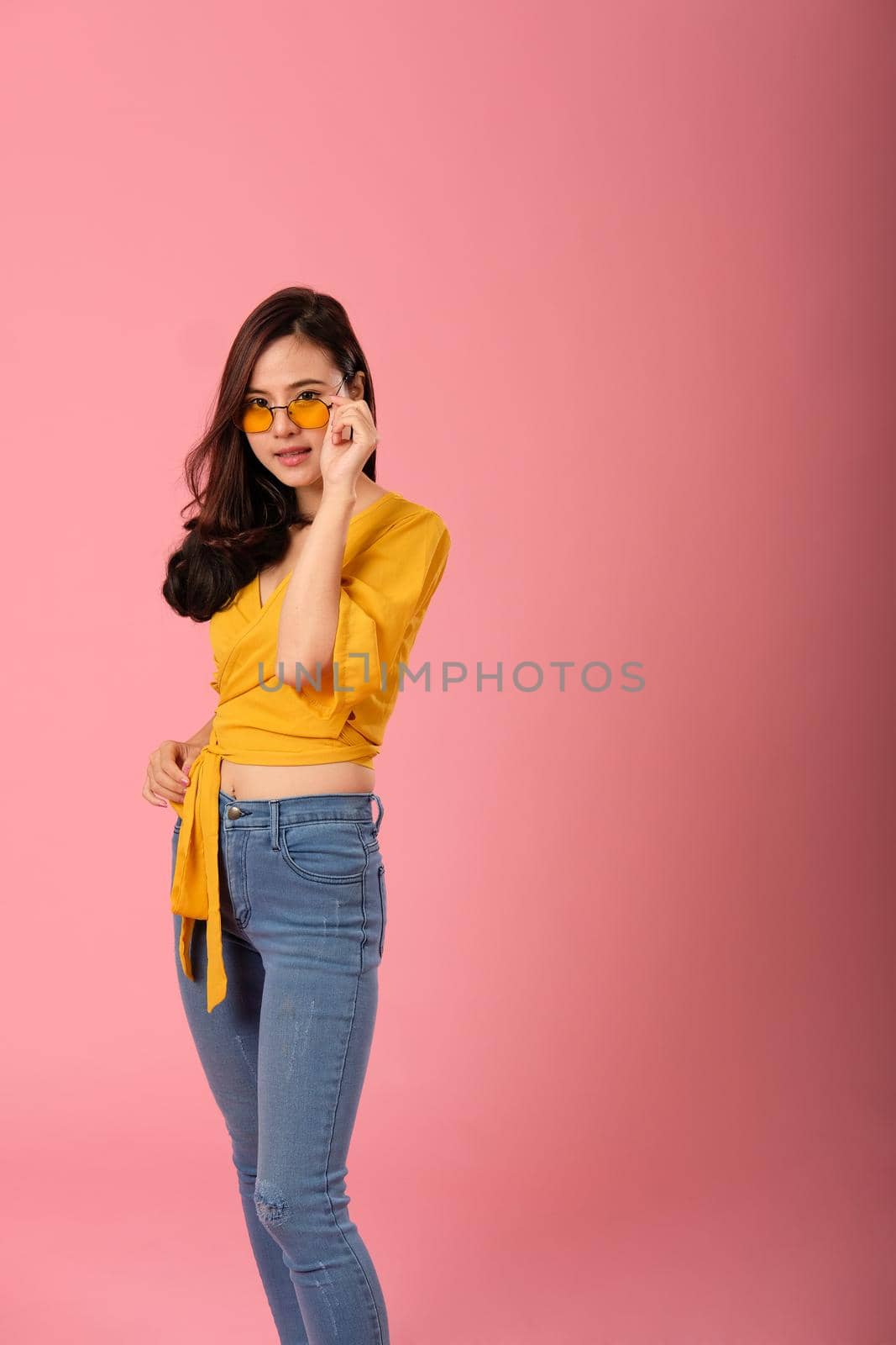 portrait of smiling young asian woman in casual clothing. studio shot