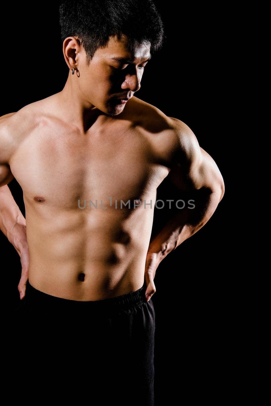 portrait of athletic muscular bodybuilder man with naked torso six pack abs. fitness workout concept