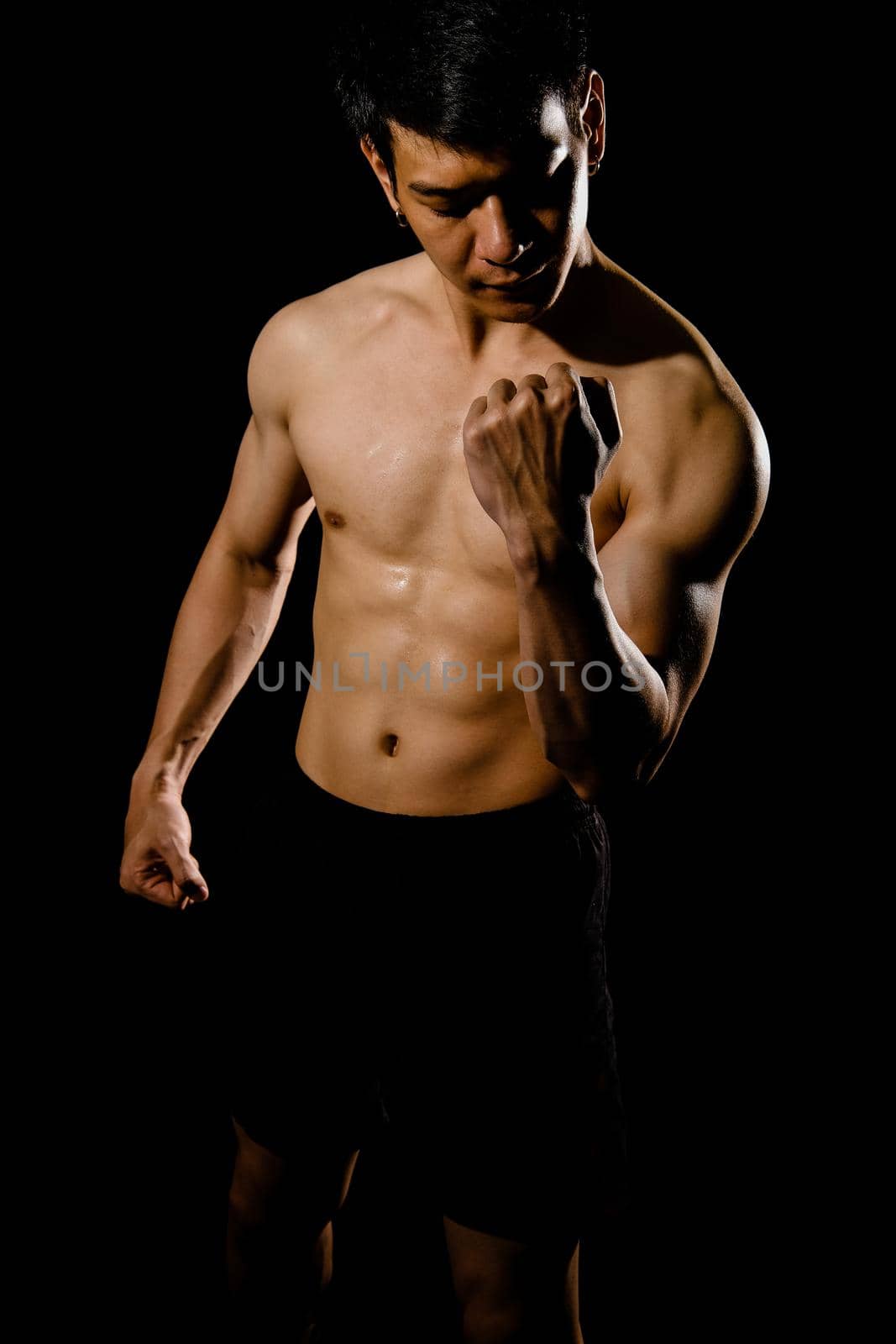 portrait of athletic muscular bodybuilder man with naked torso six pack abs. fitness workout concept