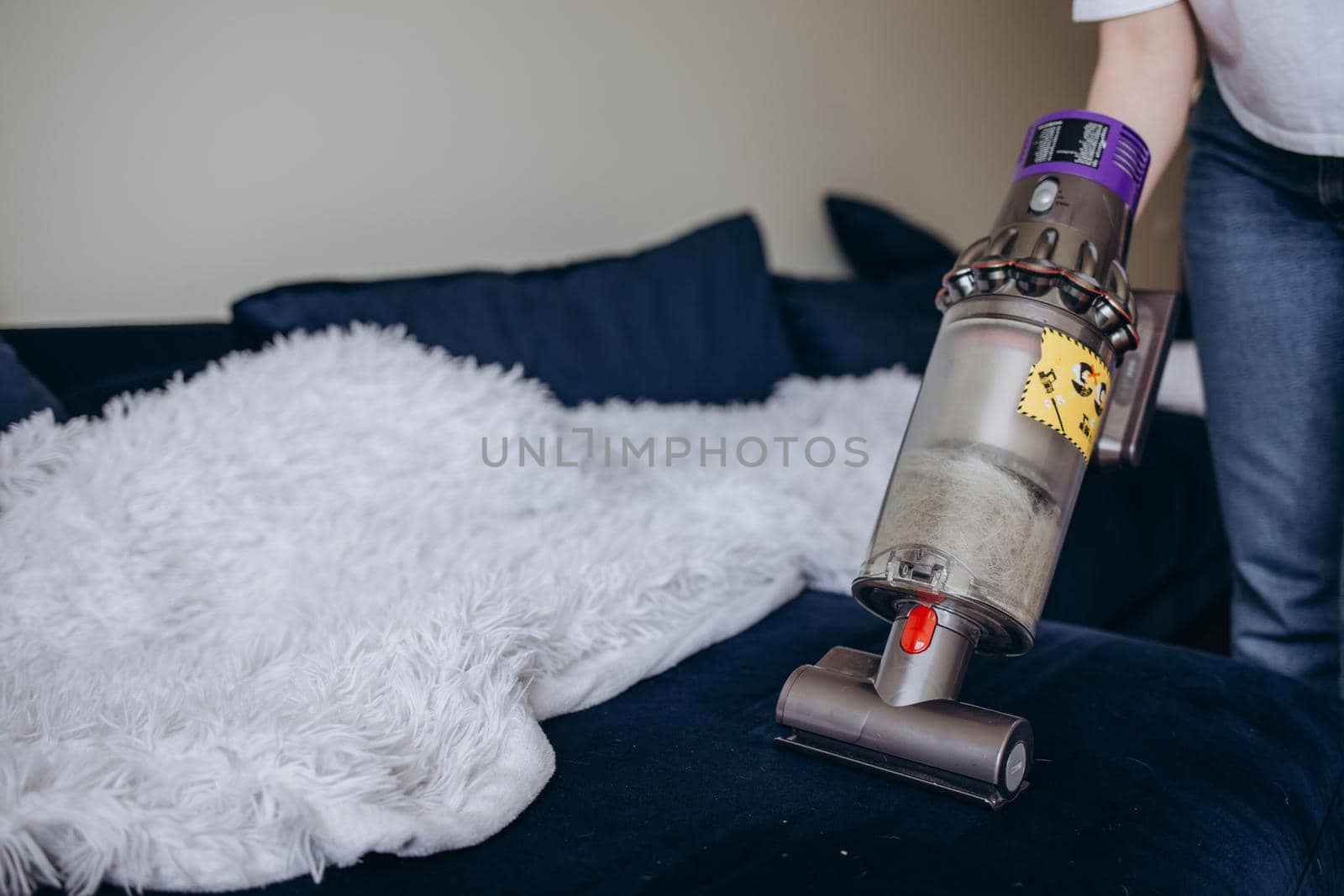 Attractive girl with vacuum cleaner on light background by fentonroma