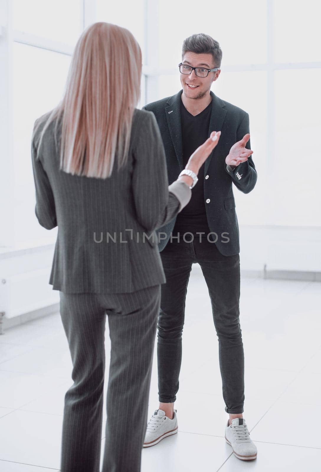 business people discussing something while standing in the office by asdf