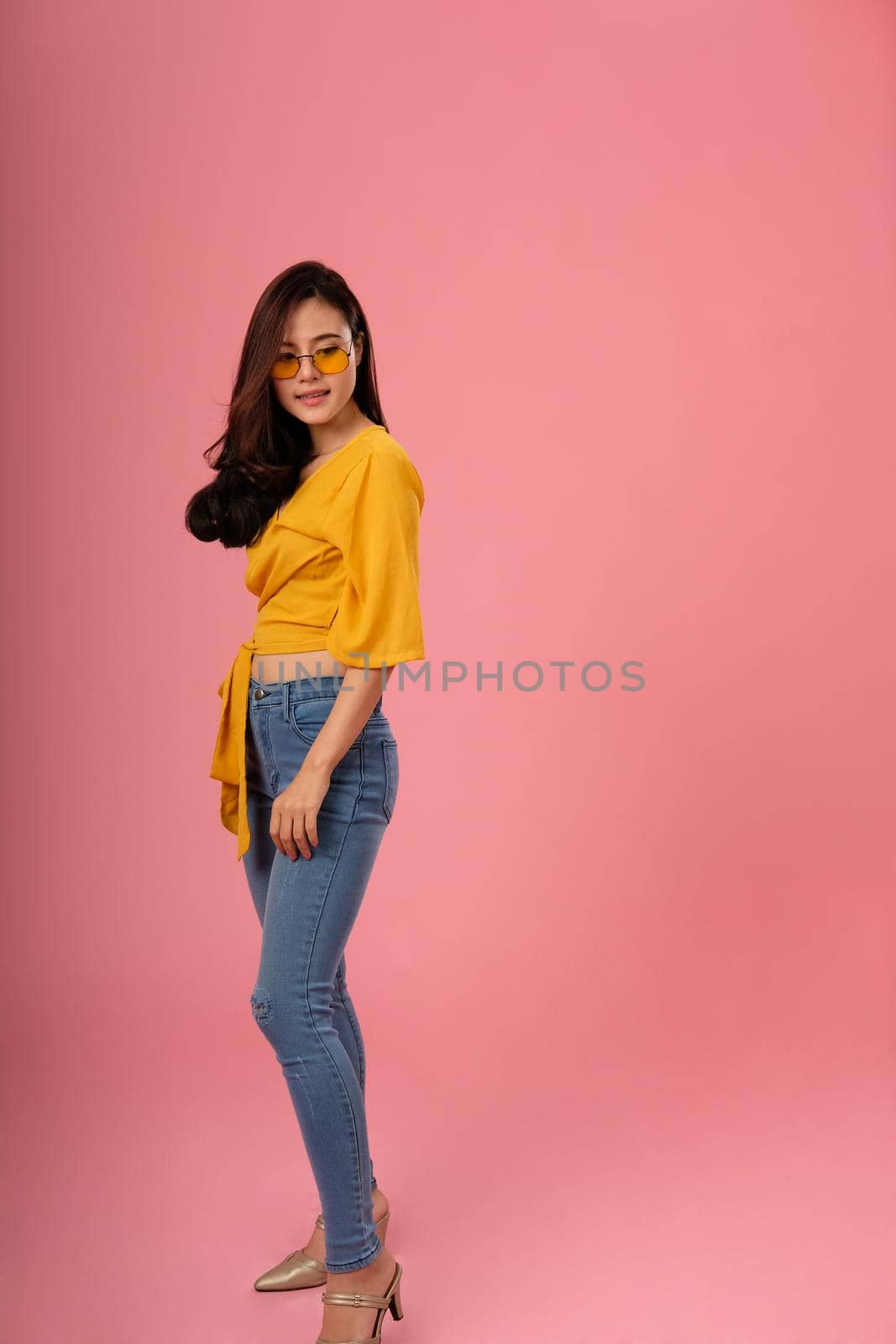 portrait of smiling young asian woman in casual clothing. studio shot