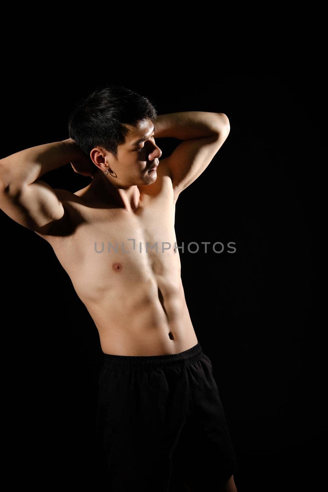 portrait of athletic muscular bodybuilder man with naked torso six pack abs. fitness workout concept