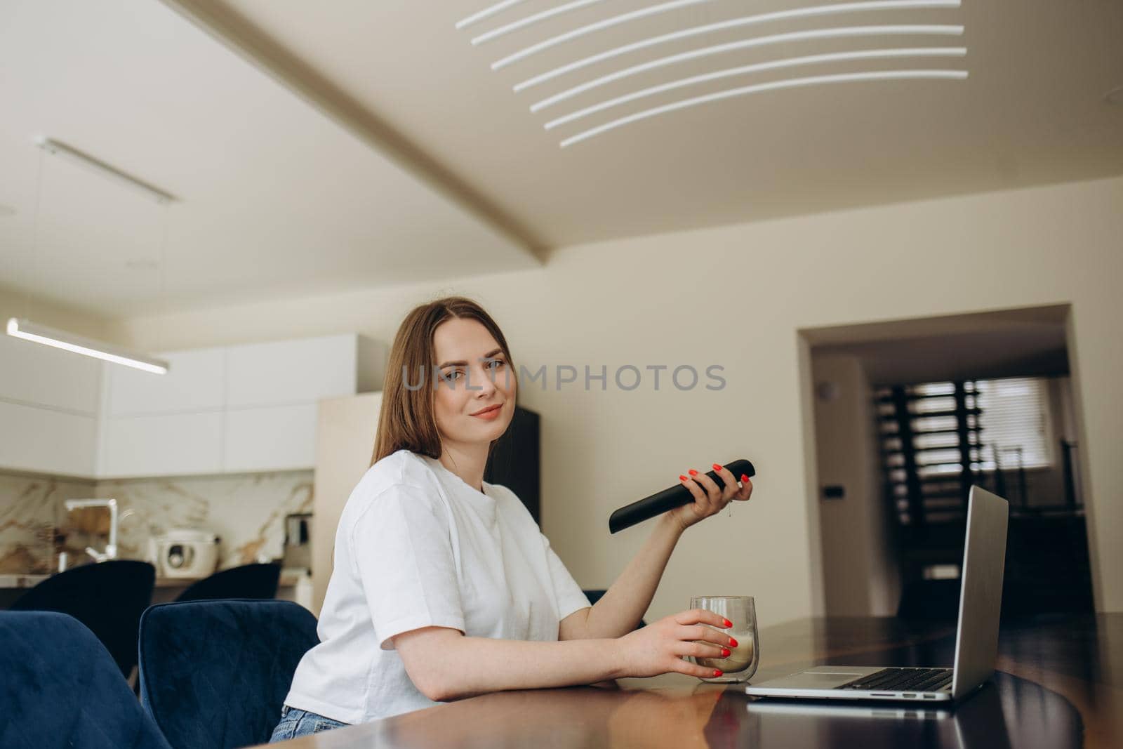 Happy homeowner resting on couch, watching movie on TV. Sport football fan relaxing at home, holding remote control, turning on football soccer game on sport channel. Digital television concept by fentonroma