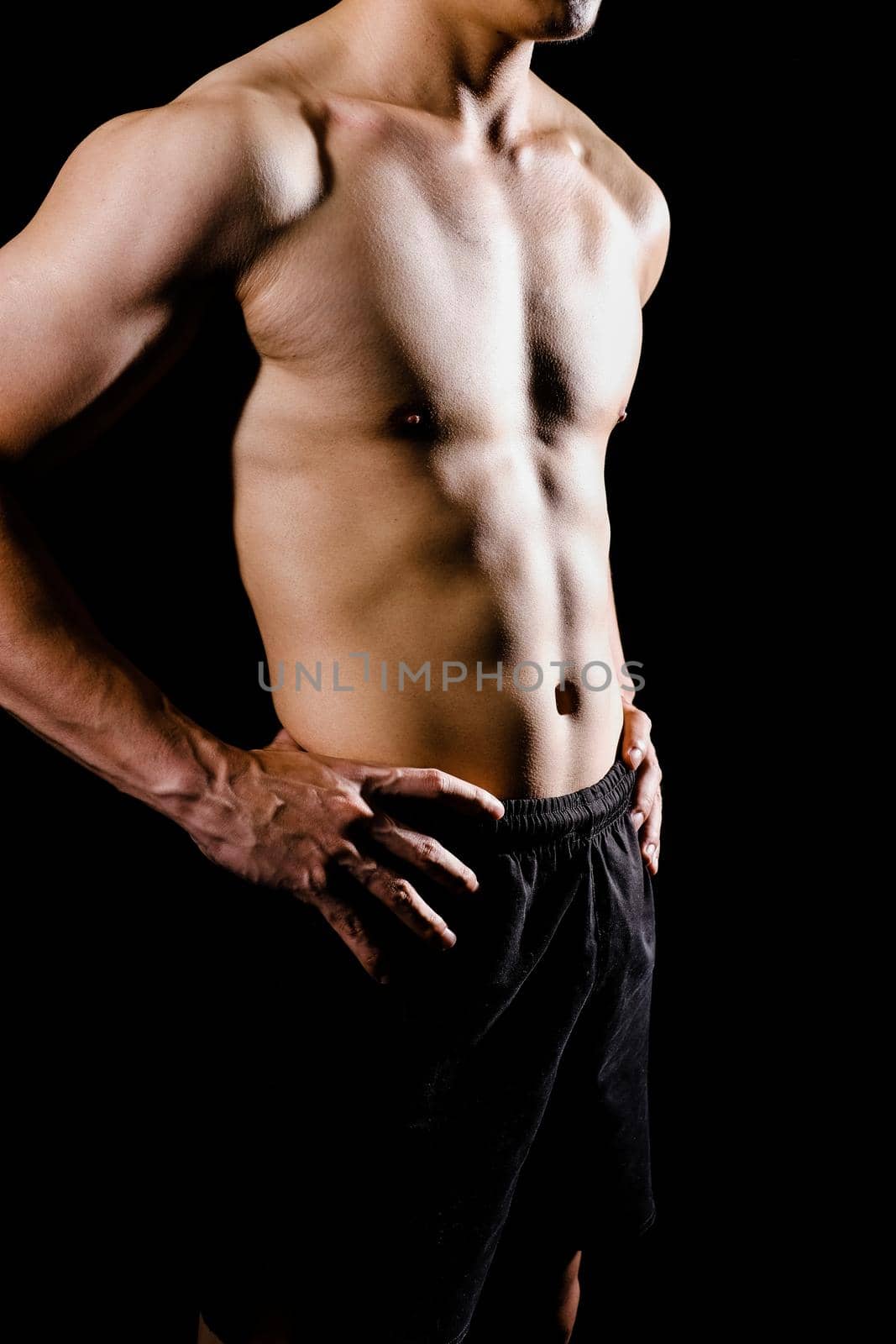 portrait of athletic muscular bodybuilder man with naked torso six pack abs. fitness workout concept