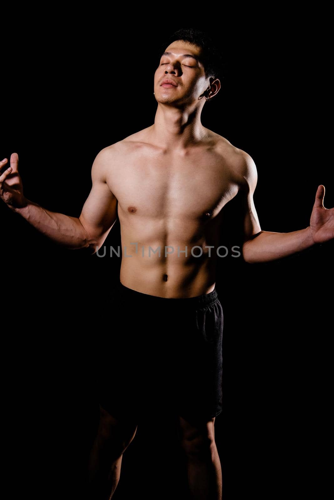 portrait of athletic muscular bodybuilder man with naked torso six pack abs. fitness workout concept