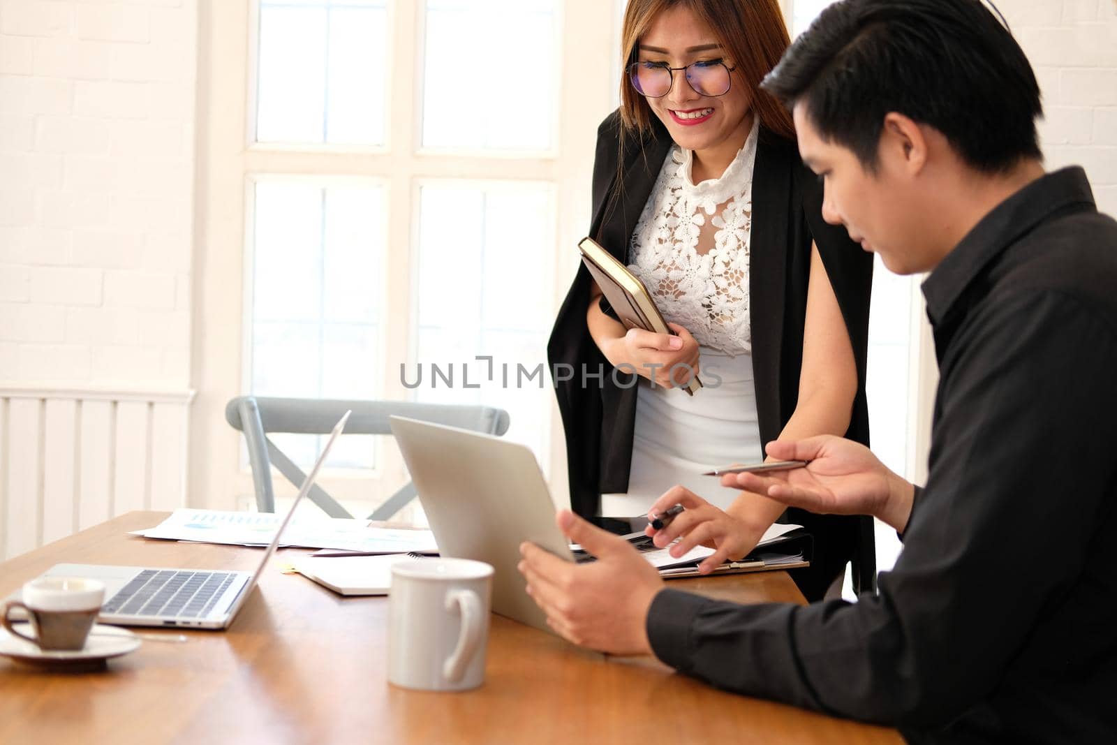 executive businesswoman advising analyzing discussing business project with co-worker team