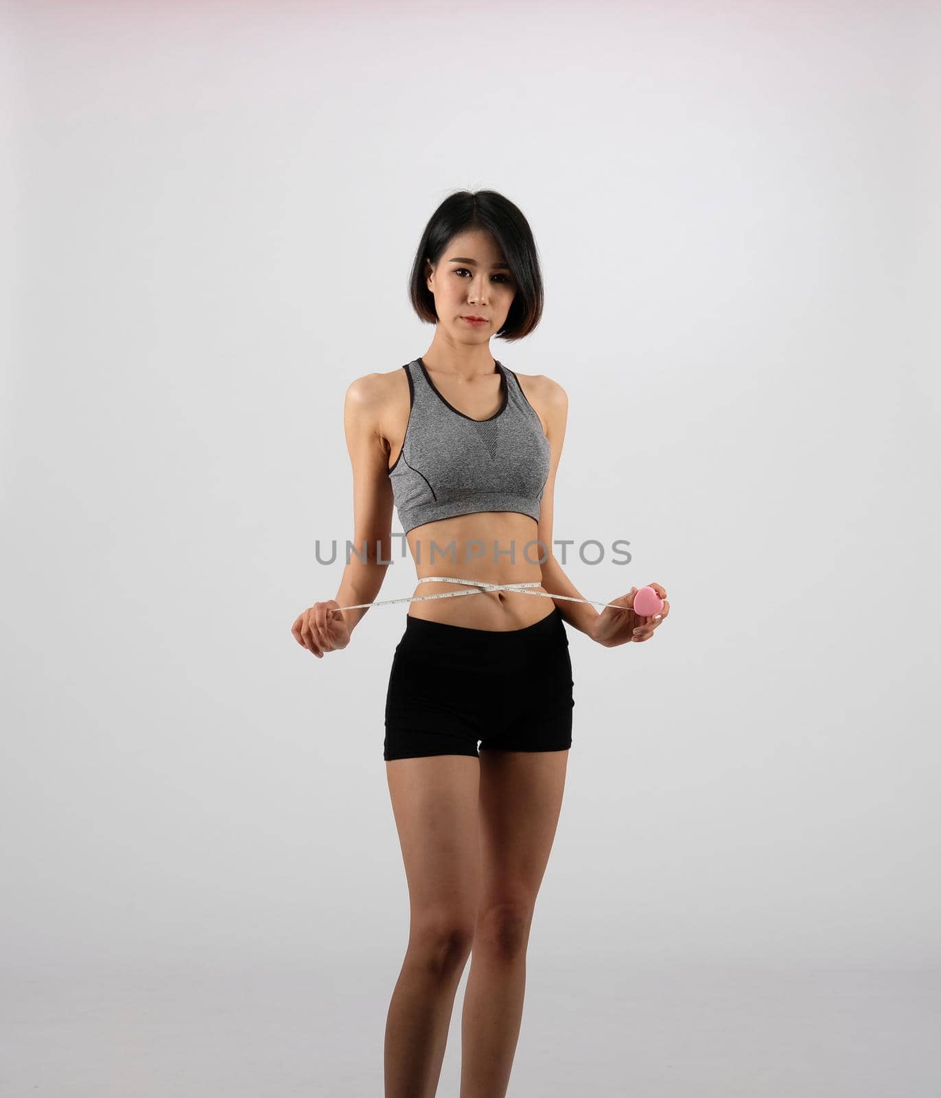 sporty fitness woman in sportswear with measuring waist with tape. healthy sport lifestyle by pp99