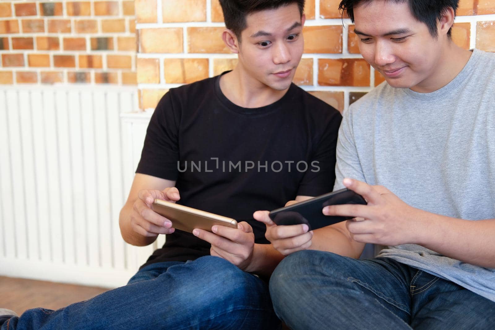 man student using smart mobile phone with friend, teenager lifestyle & social network