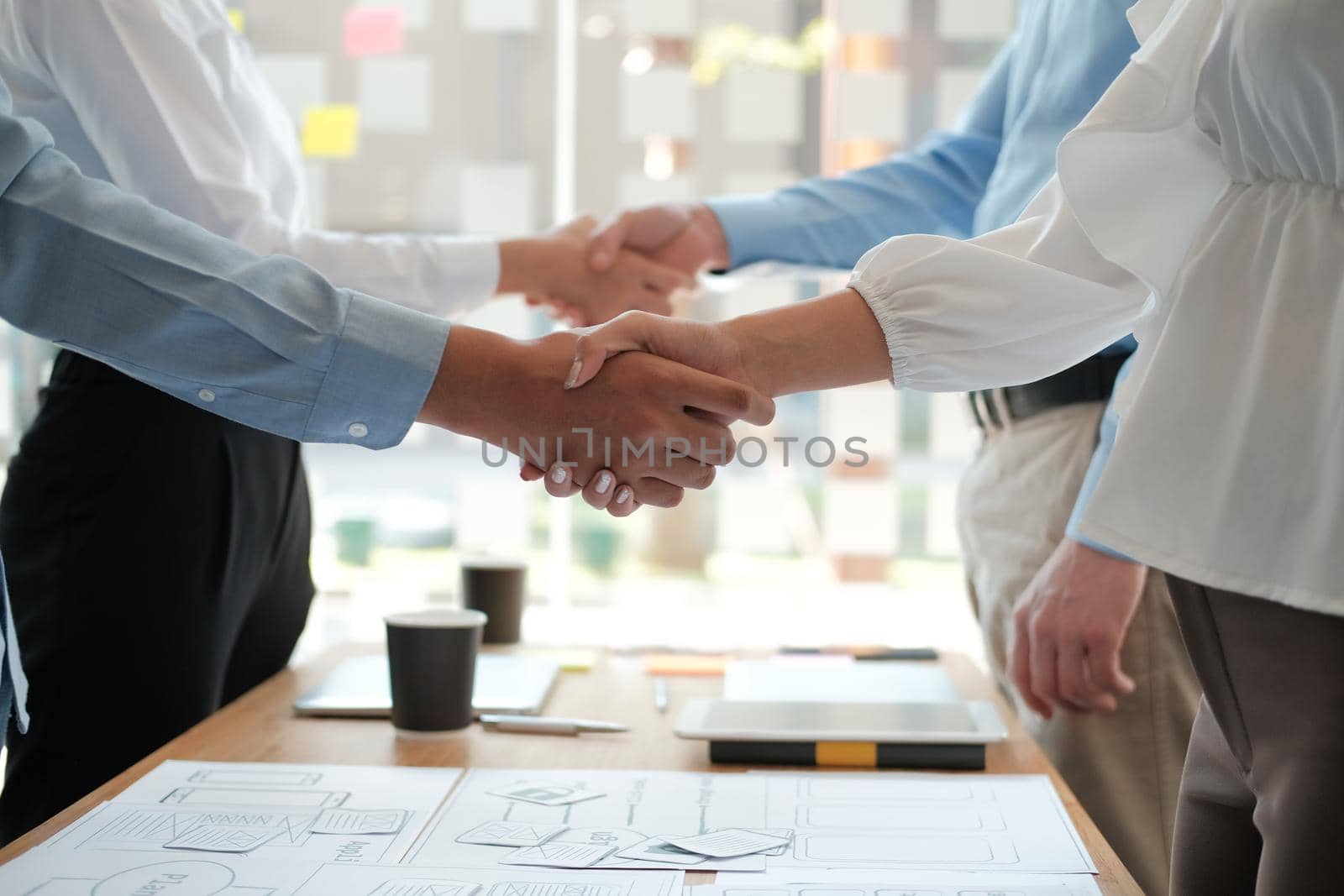 businessman shaking hands with businesswoman after UI UX desiner meeting. Business people handshaking. Greeting deal, teamwork partnership concept.