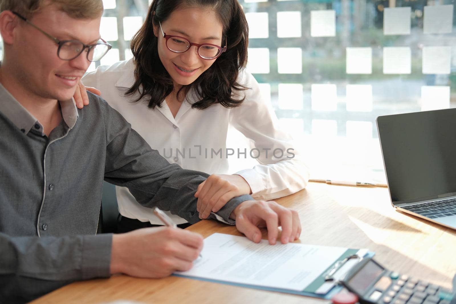 couple buying renting house car signing mortgage insurance purchase order contract with realtor real estate agent. architect designer closing dealing with customer