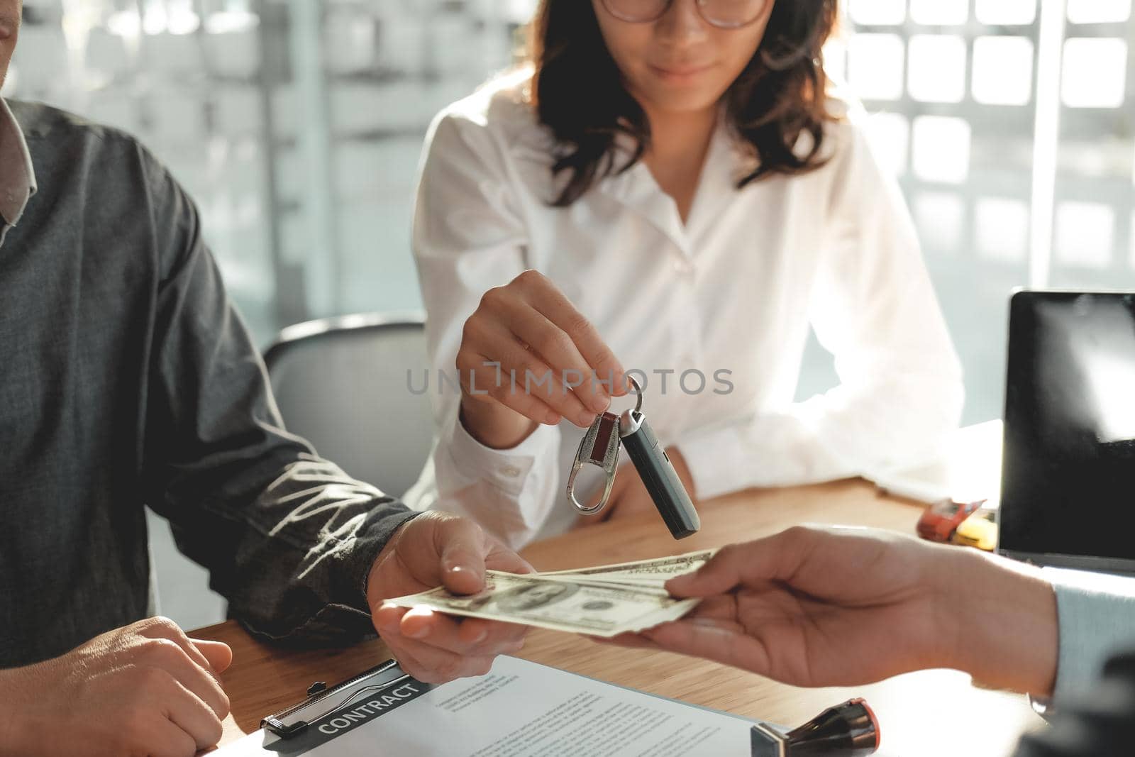 client pay for new car. salesman dealer giving key to owner. car sale & dealership in auto business