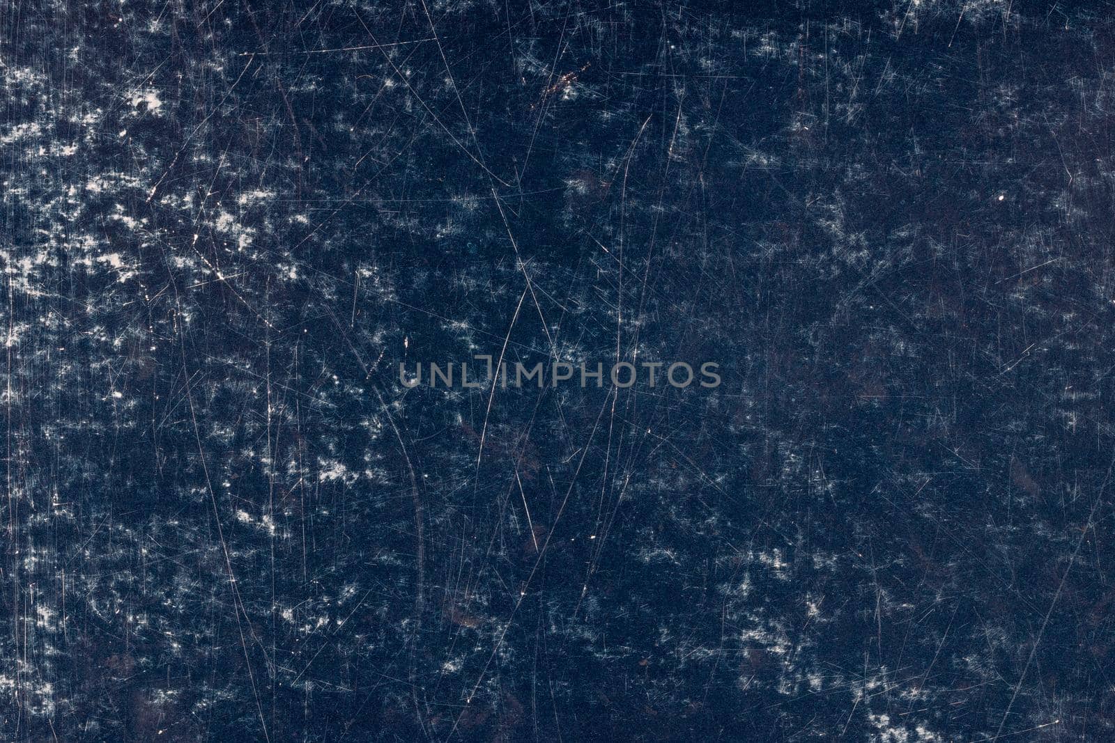 scratched dark blue surface of painted cardboard, flat full-frame background and texture by z1b