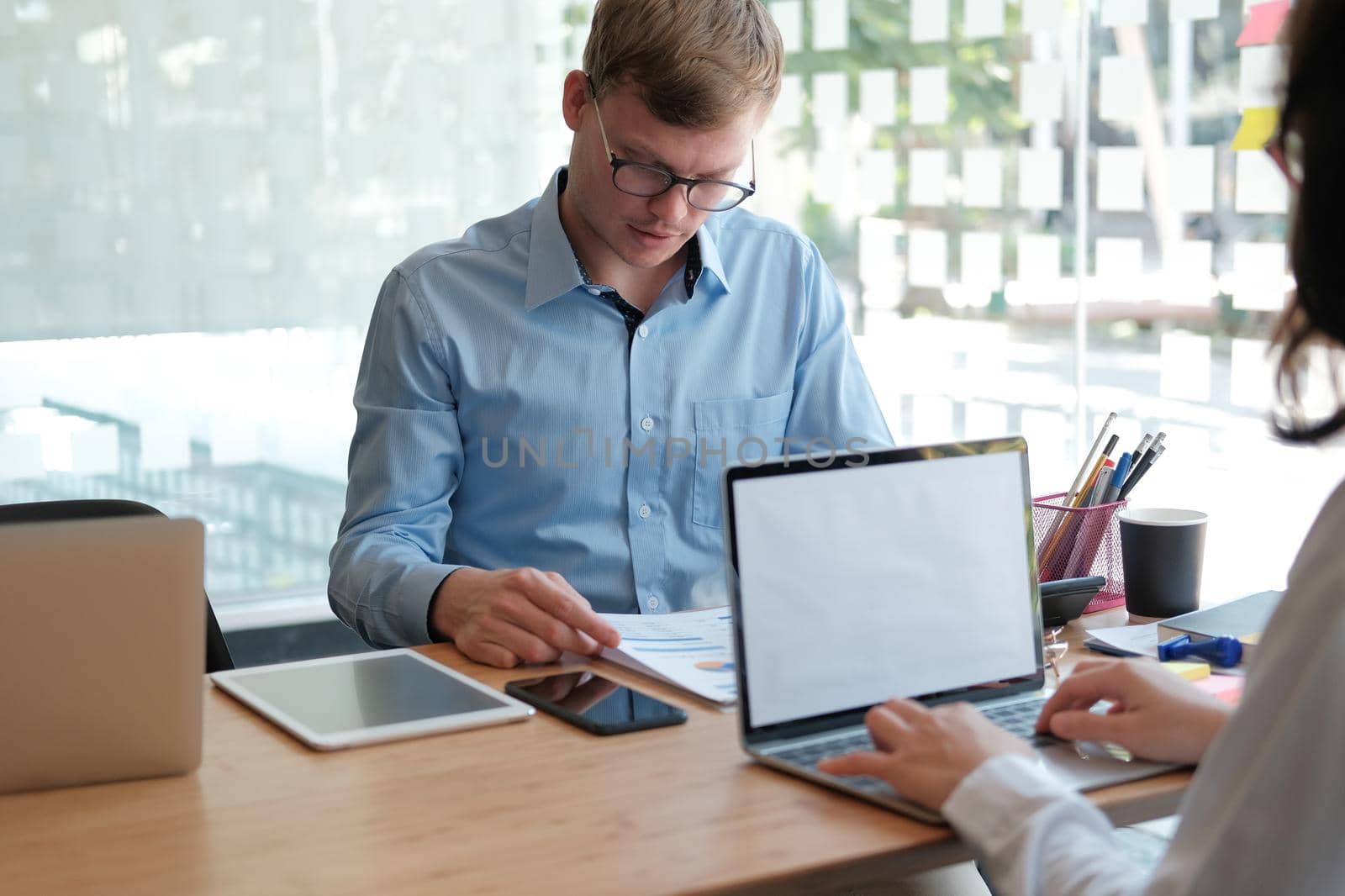 business people discussing on performance revenue in meeting. businessman working with co-worker team. financial adviser analyzing data with investor.