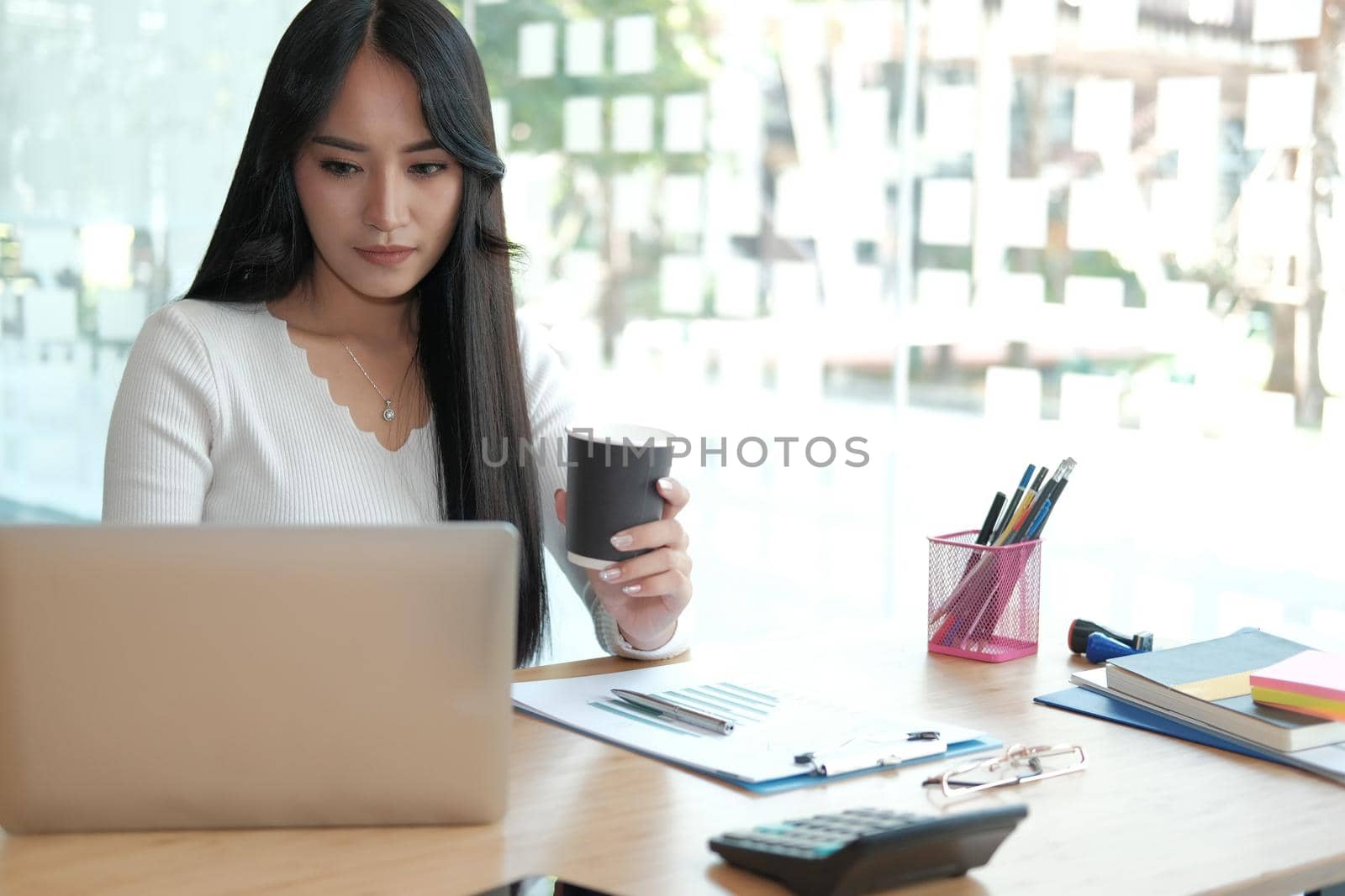 businesswoman freelancer working with computer at office. startup woman entrepreneur analyzing data at workplace. student studying doing assignment