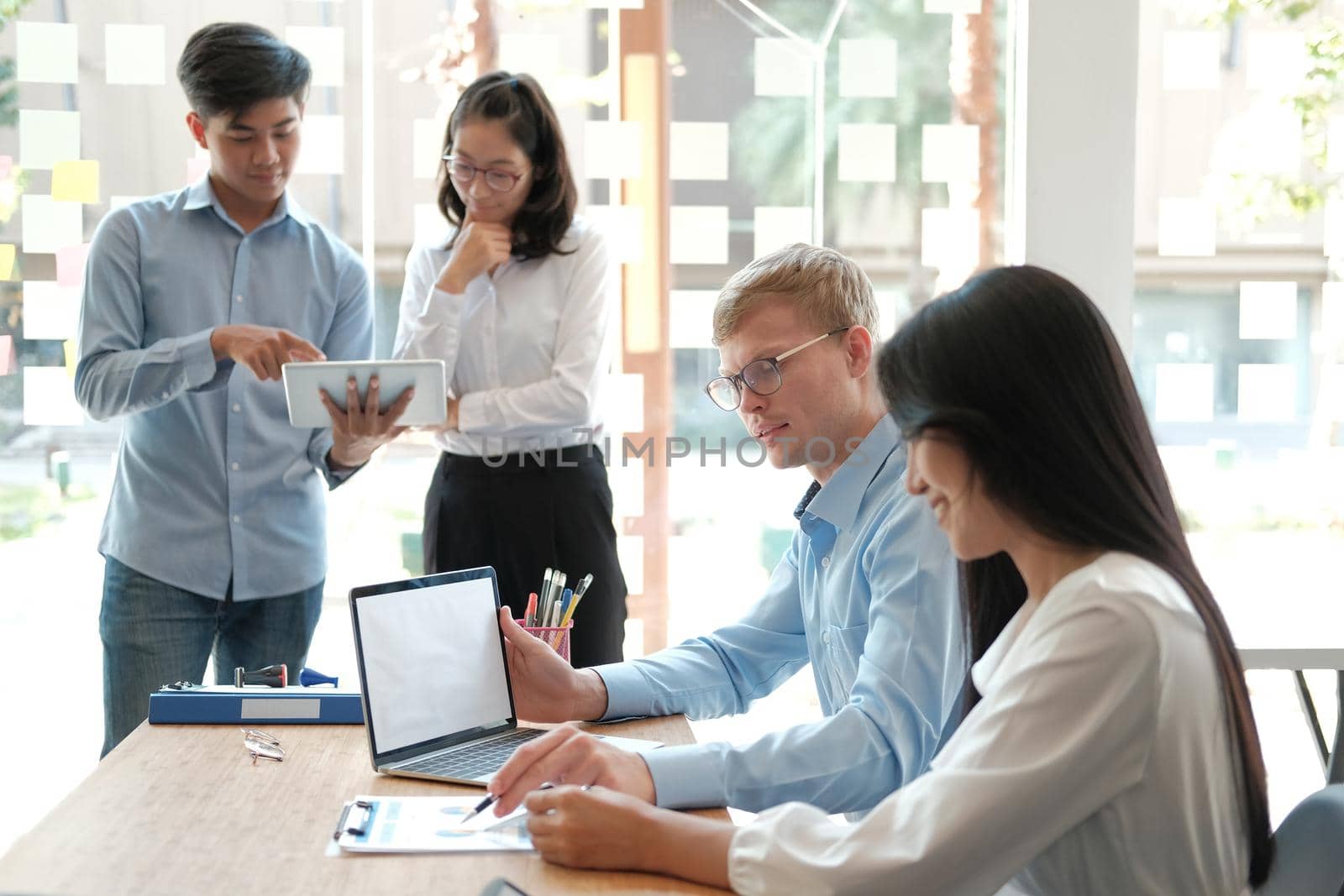 business people discussing on performance revenue in meeting. businessman working with co-worker team. financial adviser analyzing data with investor.