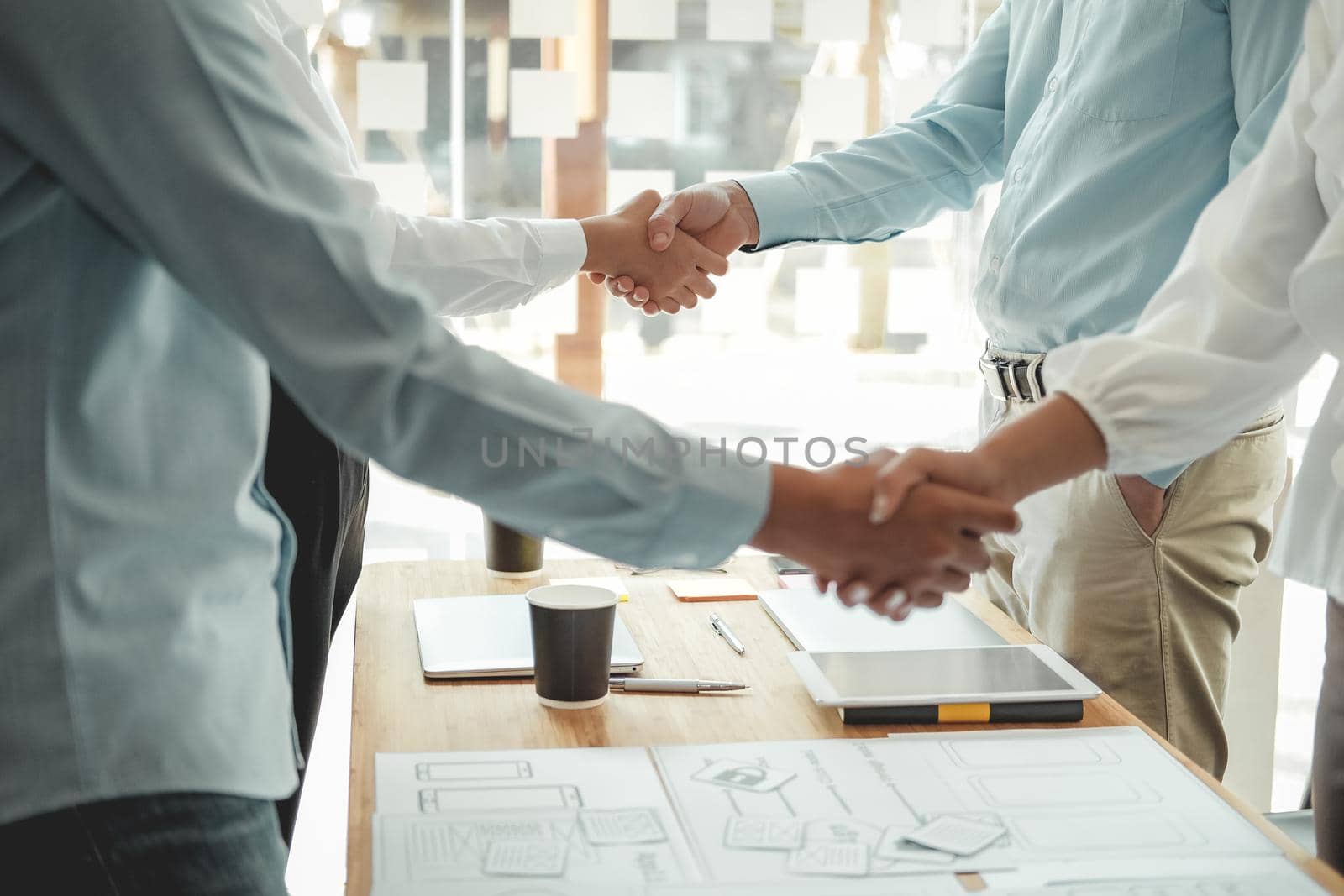 businessman shaking hands with businesswoman after UI UX desiner meeting. Business people handshaking. Greeting deal, teamwork partnership concept.
