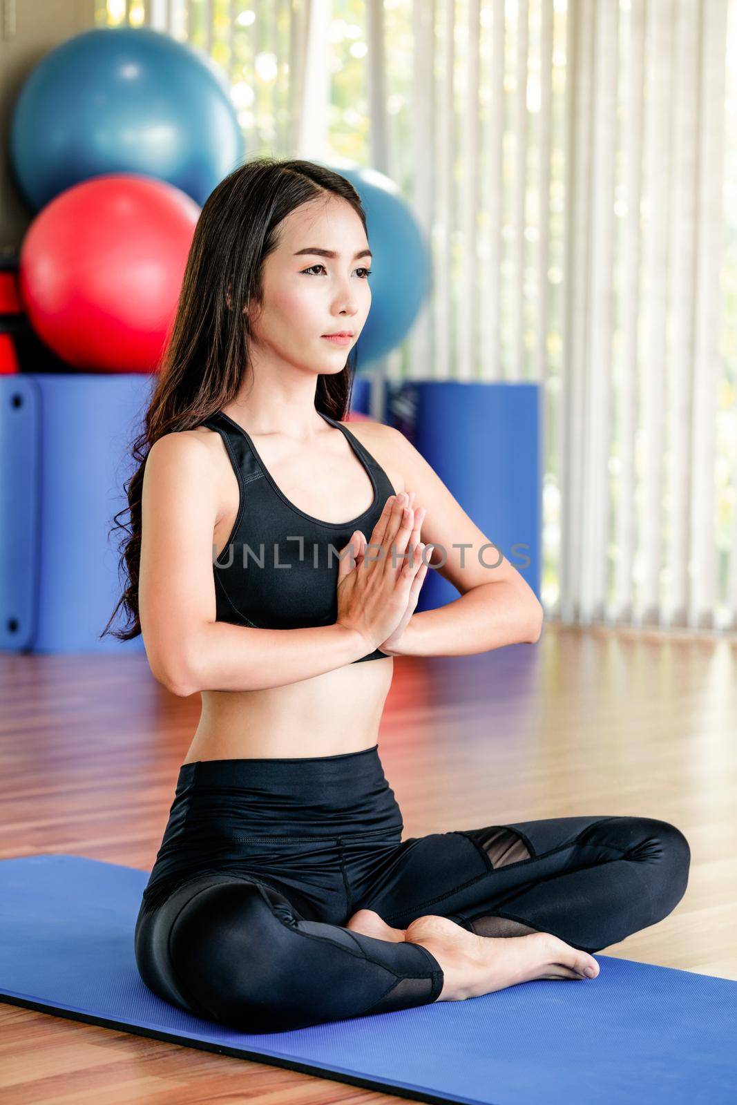 Young woman practice yoga in an gym studio. by biancoblue