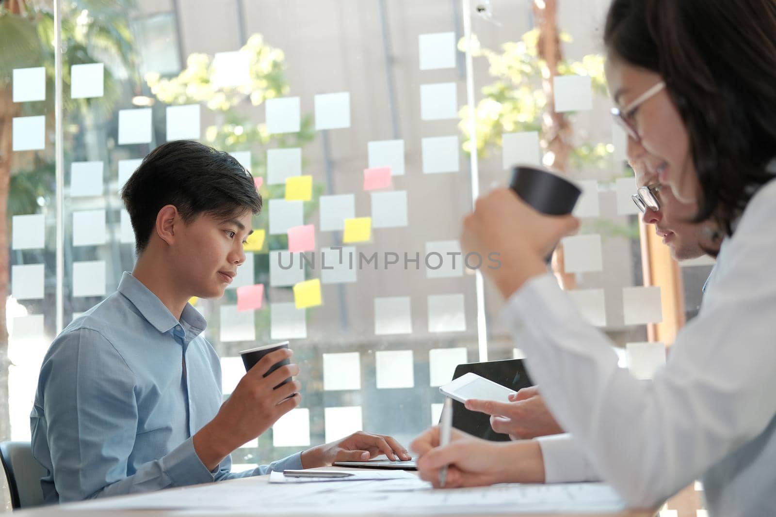 business people discussing on performance revenue in meeting. businessman working with businesswoman. by pp99