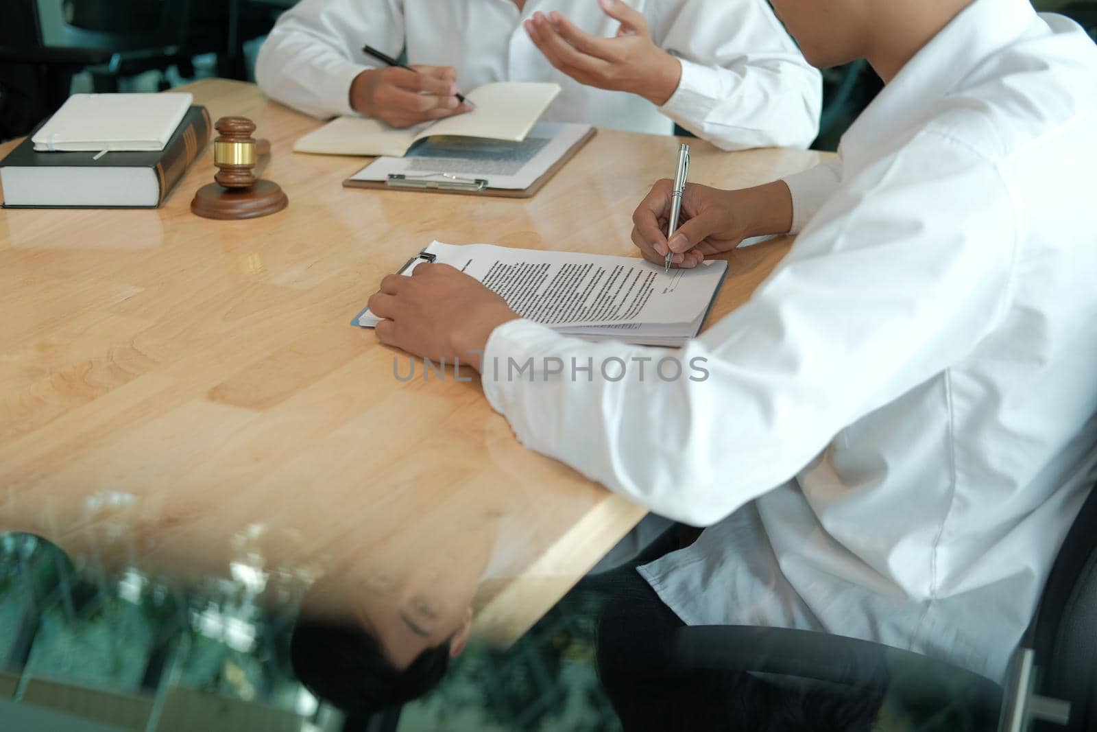 businessman consulting lawyer & signing contract agreement. team meeting at law firm