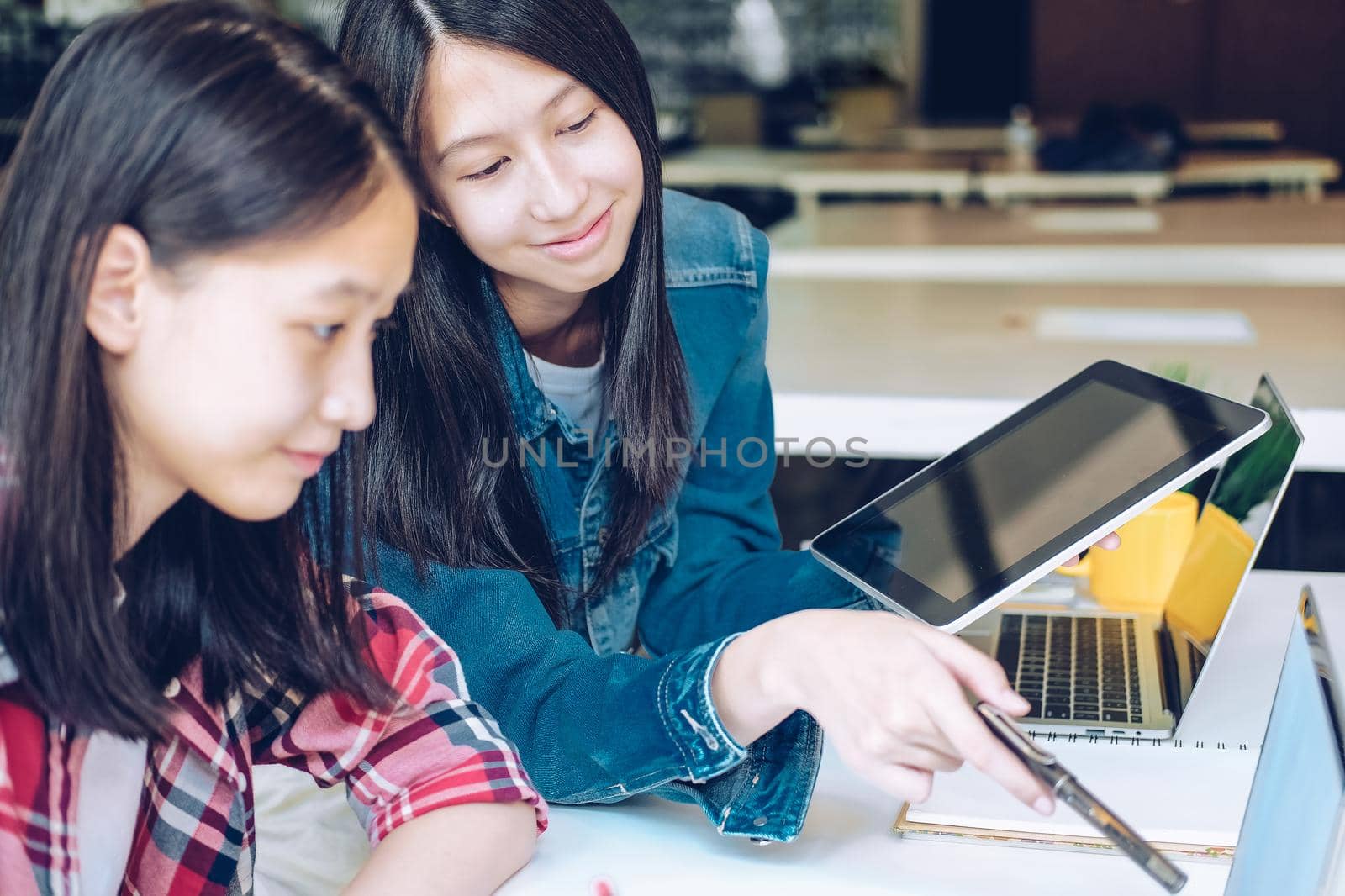 girl teenager college high school student studying with tablet computer laptop