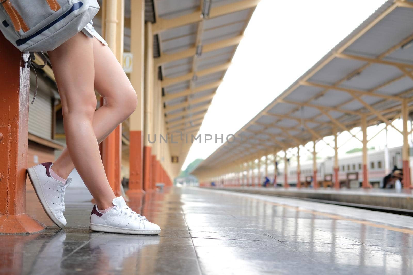 young asian woman  backpacker traveler with backpack at train station. journey trip travel concept