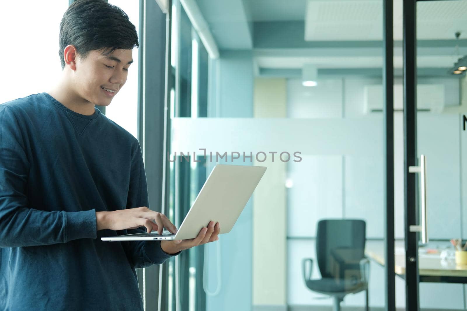 startup male freelancer working with computer at office. man entrepreneur analyzing data at workplace. student studying doing assignment