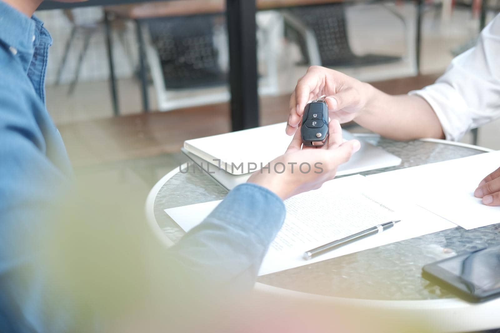 salesman dealer giving car key to new owner. car sale & dealership in auto business