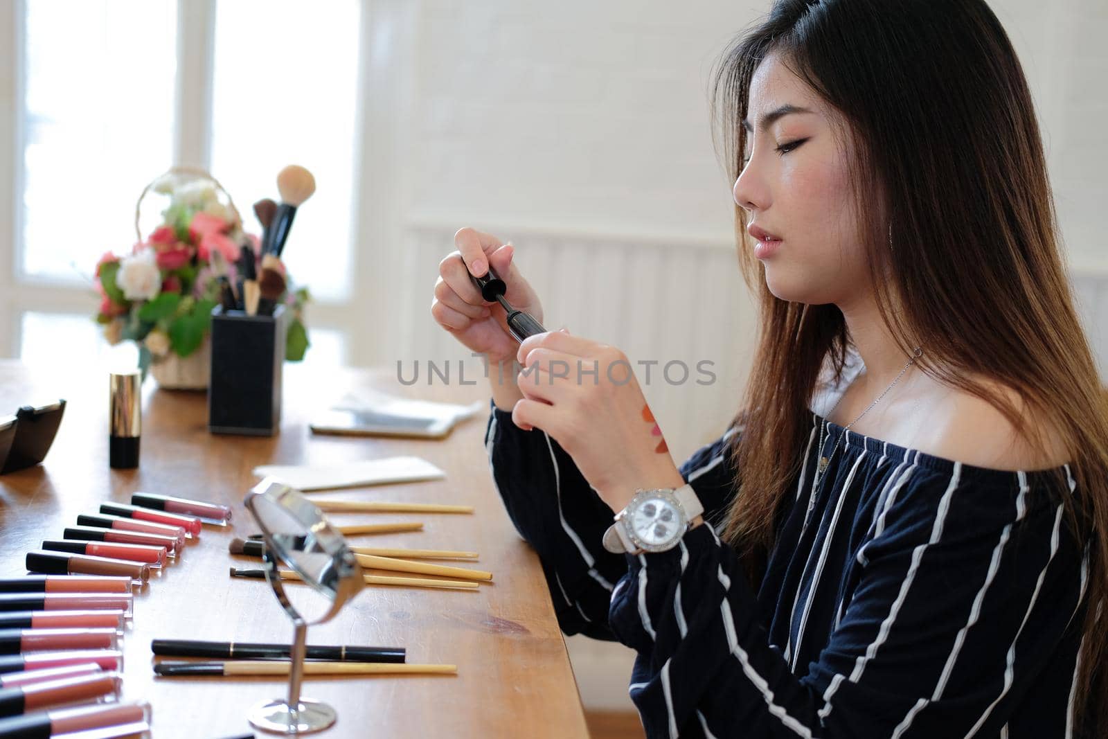 asian woman applying makeup cosmetic. make up beauty concept