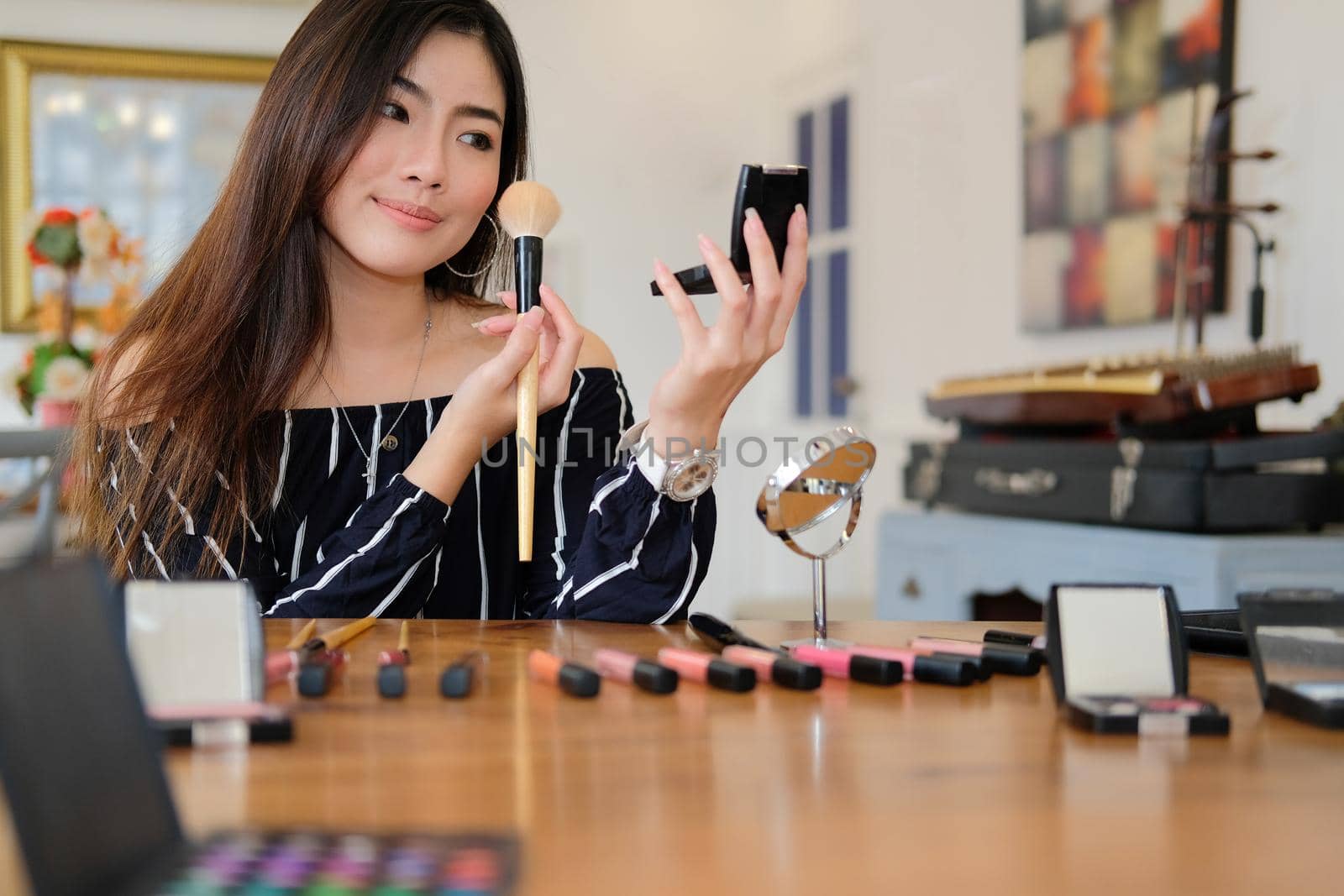 asian woman applying makeup cosmetic. make up beauty concept