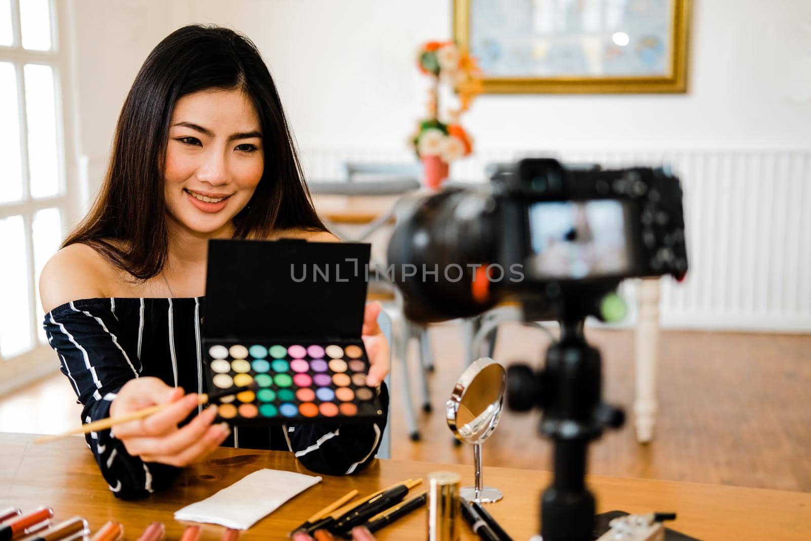 beauty blogger live broadcasting cosmetic makeup tutorial on social media. vlogger recording vlog video. influencer marketing