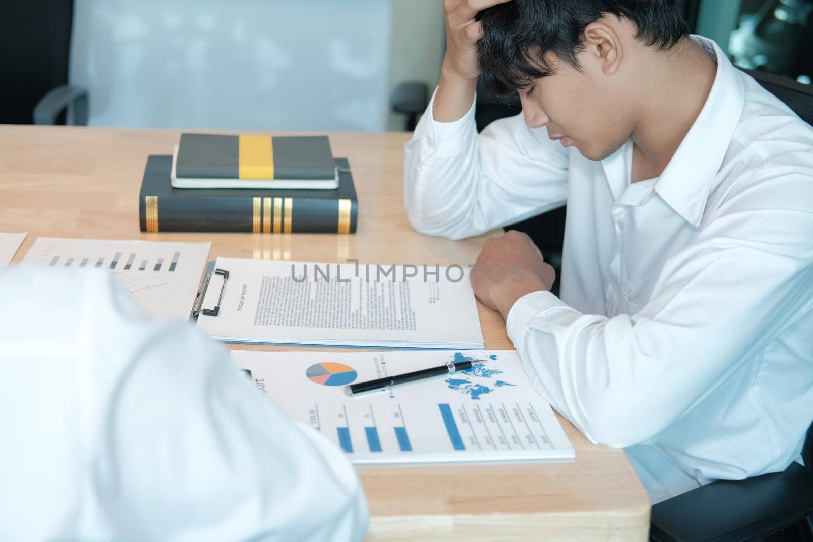 man feeling tired, frustrated stressed from hard work. exhausted businessman have headache at workplace.