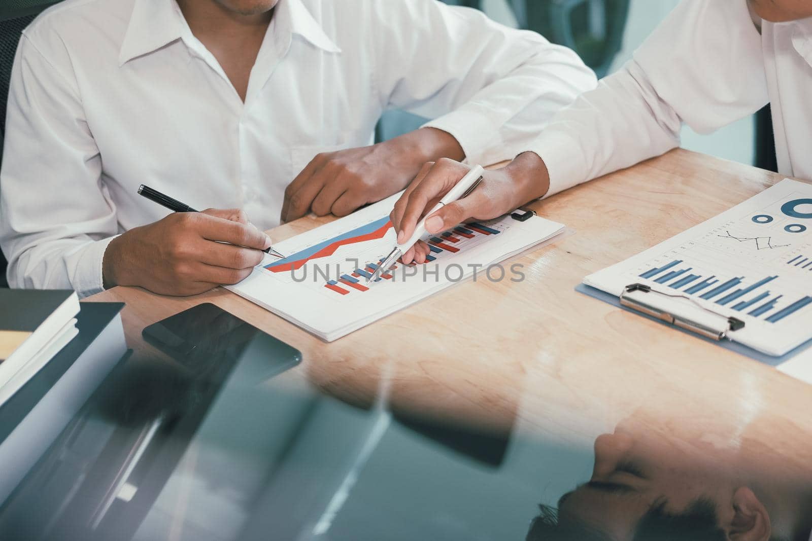 financial adviser analyzing performance revenue with investor. business people discussing in meeting. businessman working with co-worker team.